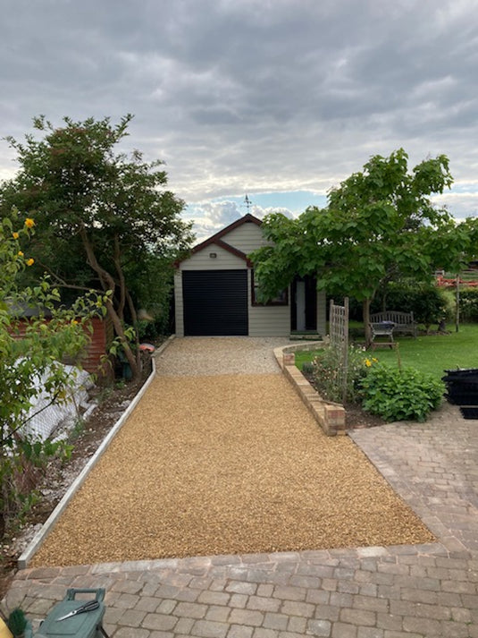 Gravel driveway leading up to garage